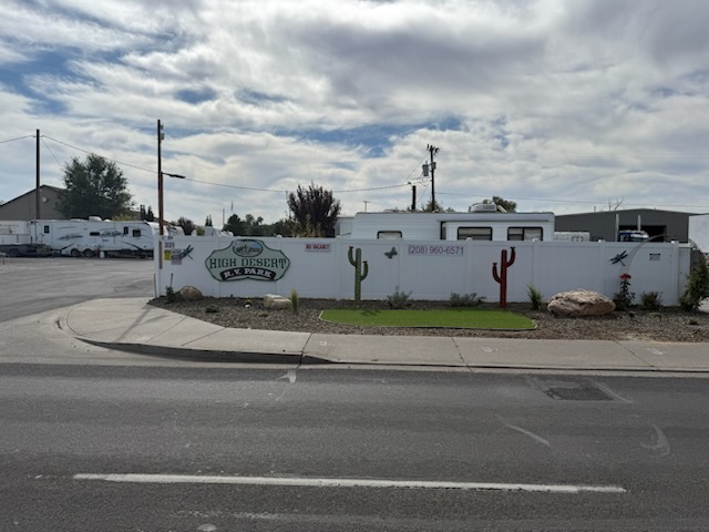The High Desert RV Park sign on the white fence along Addison West